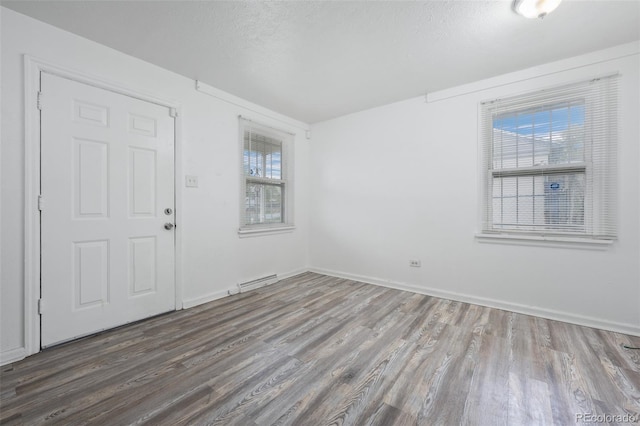 3715 N Jackson St, Denver, CO 80205 - foyer entrance featuring wood finished floors, baseboards, and a textured ceiling