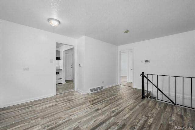 3715 N Jackson St, Denver, CO 80205 - unfurnished room featuring wood finished floors, baseboards, and a textured ceiling