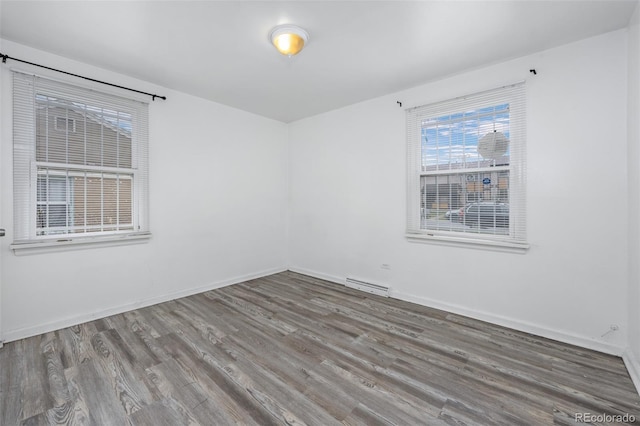 3715 N Jackson St, Denver, CO 80205 - spare room featuring wood finished floors and baseboards