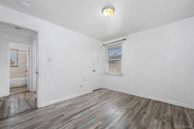 3715 N Jackson St, Denver, CO 80205 - unfurnished room with wood finished floors, plenty of natural light, and baseboards