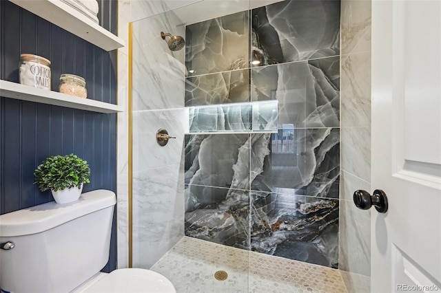 bathroom with tiled shower and toilet