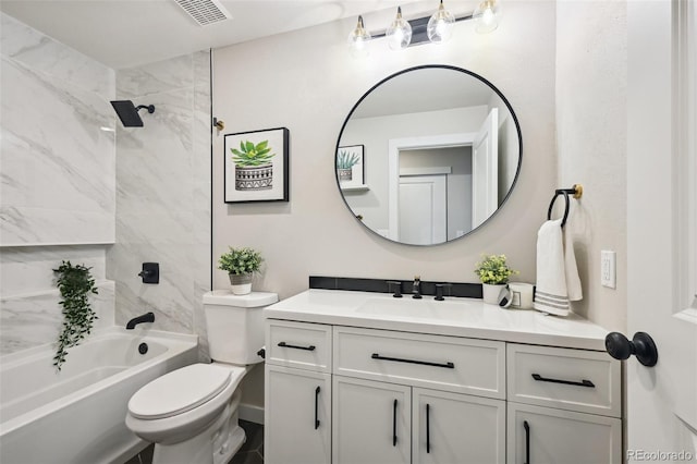 full bathroom with toilet, vanity, and tiled shower / bath