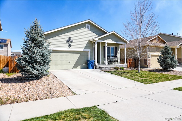 ranch-style house with covered porch, concrete driveway, an attached garage, and fence