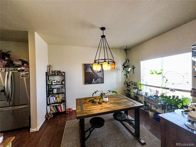dining space featuring dark wood finished floors and baseboards