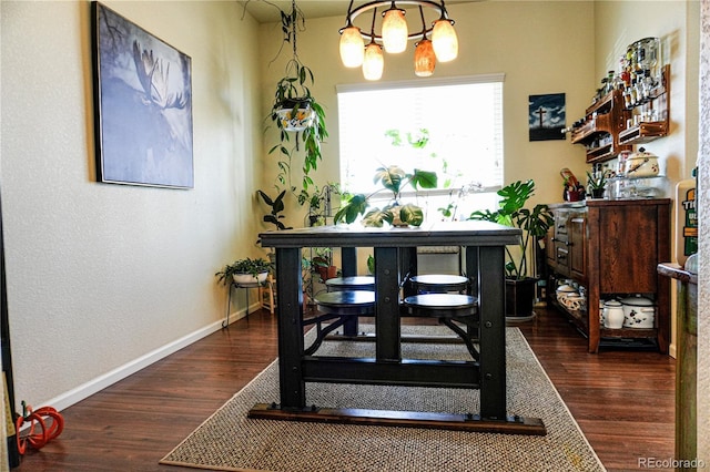 dining area with baseboards and dark wood-style floors