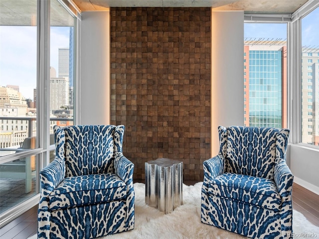 living area with a view of city and a wall of windows