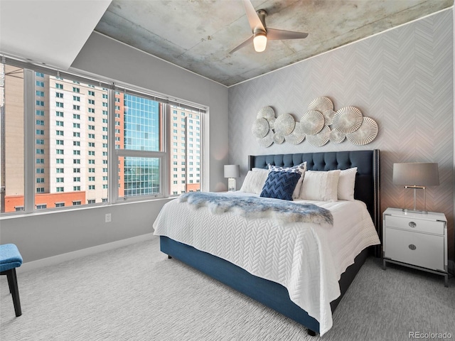 bedroom featuring baseboards, a ceiling fan, carpet, and wallpapered walls
