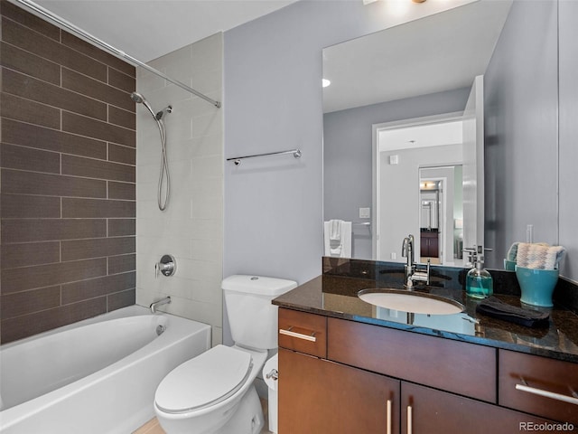 bathroom with toilet, vanity, and tub / shower combination