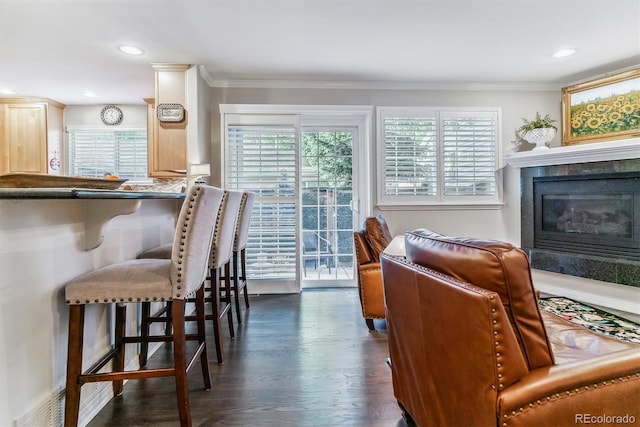 living room with ornamental molding, dark wood-style flooring, a fireplace, and recessed lighting