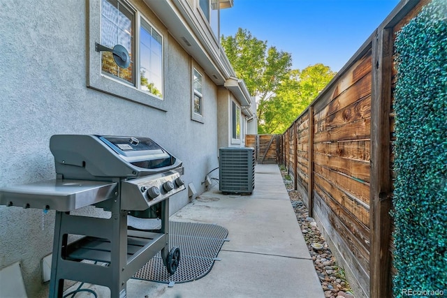 view of property exterior featuring cooling unit, fence, and stucco siding