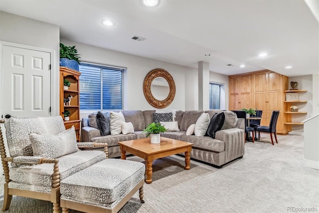 living room with light carpet, visible vents, and recessed lighting