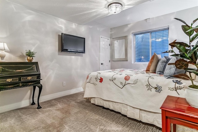 bedroom featuring carpet and baseboards