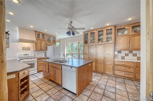 kitchen featuring backsplash, a sink, white appliances, ceiling fan, and custom range hood