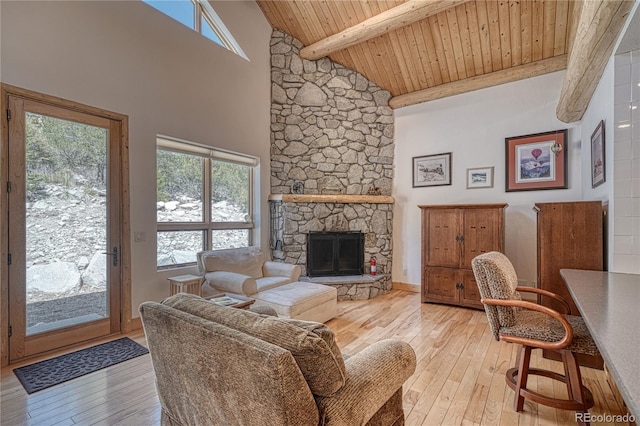 living area with a healthy amount of sunlight, light wood finished floors, and wood ceiling