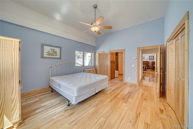 bedroom with a ceiling fan and light wood-style flooring