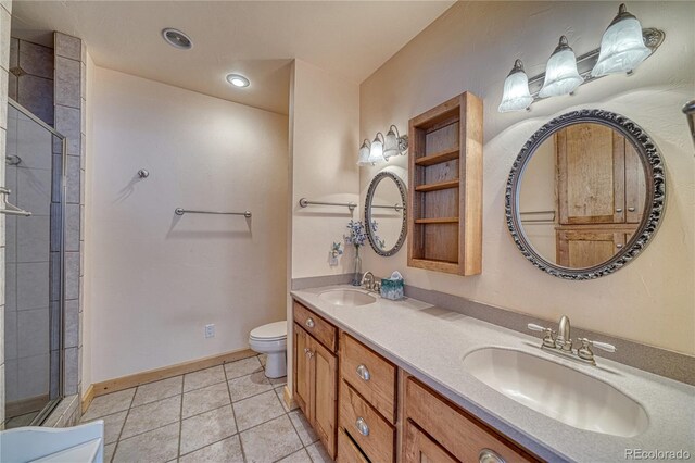 full bath featuring toilet, a sink, double vanity, and tiled shower