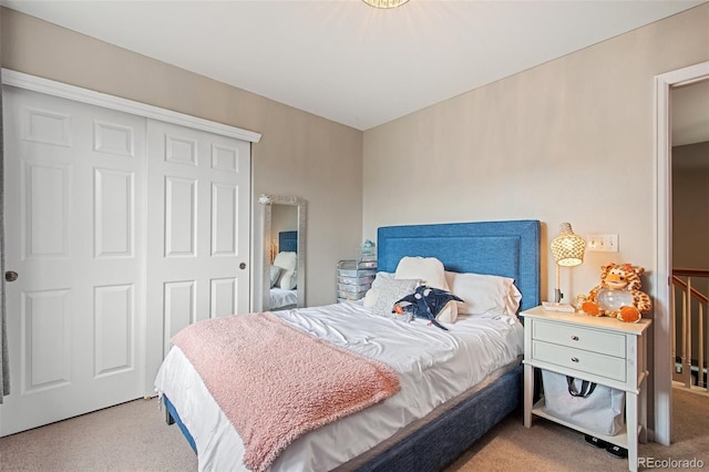 carpeted bedroom with a closet