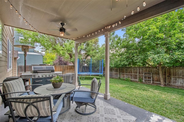 view of patio / terrace with grilling area and a trampoline