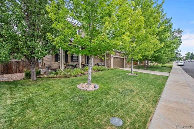 obstructed view of property with a front lawn and a garage