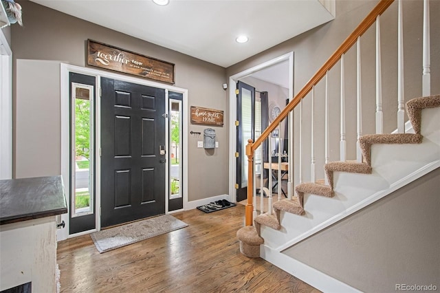 entryway with hardwood / wood-style floors