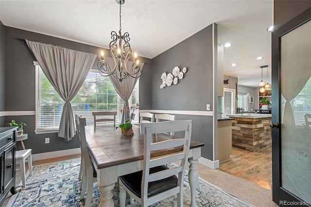 dining room with a chandelier and light hardwood / wood-style flooring