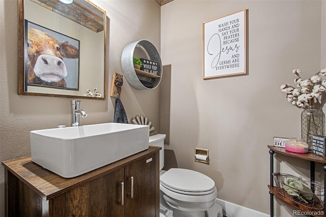 bathroom featuring toilet and vanity