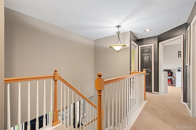 hallway featuring light colored carpet