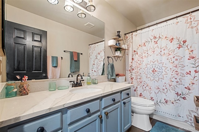 bathroom with toilet and vanity