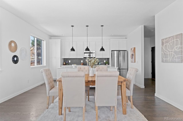 dining room with light wood-style flooring and baseboards