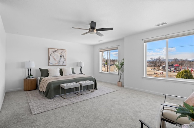 bedroom featuring carpet flooring, baseboards, visible vents, and ceiling fan