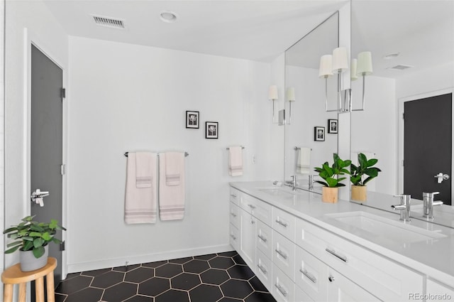 bathroom with a sink, visible vents, and double vanity