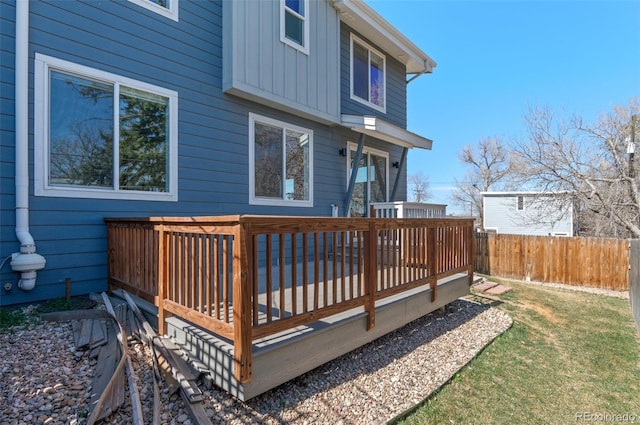 wooden deck with a lawn and fence