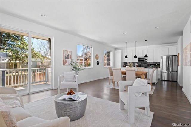 living room featuring recessed lighting, baseboards, and dark wood-style flooring