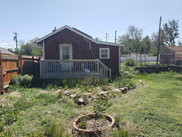 1314 16th Ave, Greeley, CO 80631 - rear view of house featuring a wooden deck and a garden