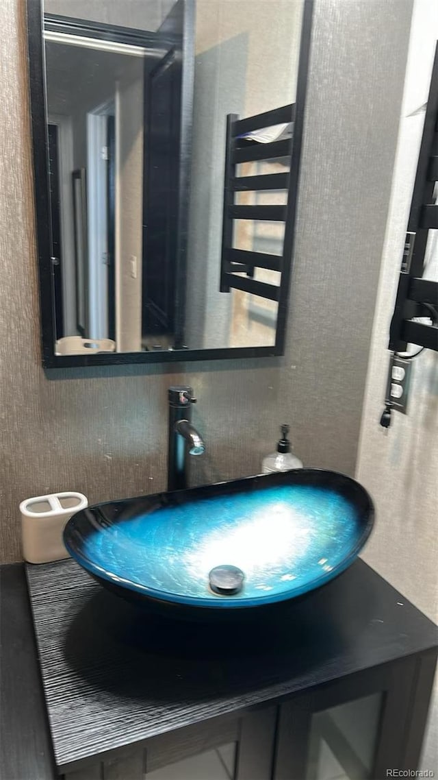 bathroom featuring vanity and a towel warmer