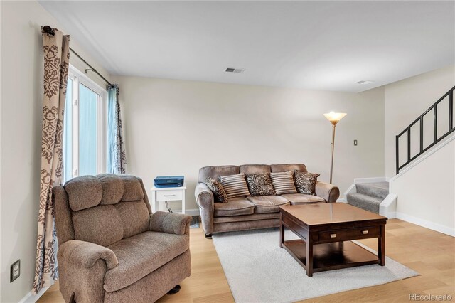7933 Chase Cir Unit 182, Arvada, CO 80003 - living room with stairs and light wood-type flooring