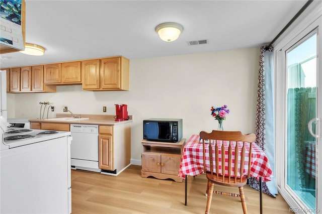 7933 Chase Cir Unit 182, Arvada, CO 80003 - kitchen featuring white appliances, light wood-style flooring, light brown cabinetry, and light countertops