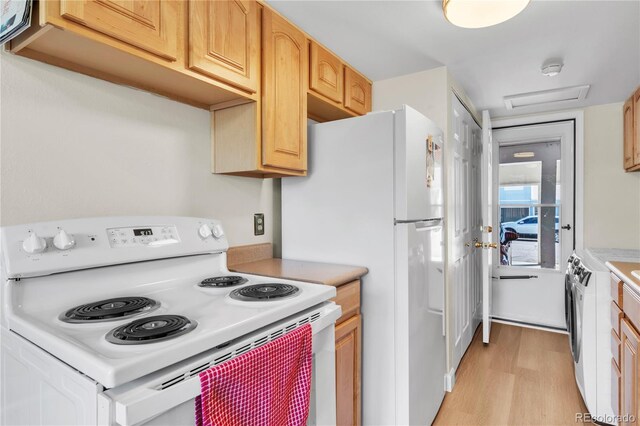 7933 Chase Cir Unit 182, Arvada, CO 80003 - kitchen featuring white appliances, light wood finished floors, light countertops, and washer / dryer
