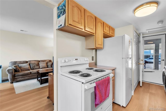 7933 Chase Cir Unit 182, Arvada, CO 80003 - kitchen with white electric range oven, light wood-type flooring, light countertops, open floor plan, and light brown cabinetry