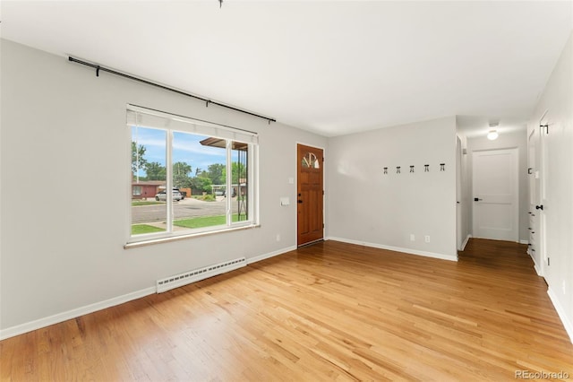 8675 Calvin Dr, Arvada, CO 80002 - entryway featuring a baseboard radiator and light wood finished floors