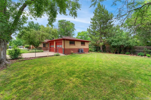 8675 Calvin Dr, Arvada, CO 80002 - fenced backyard featuring an attached garage