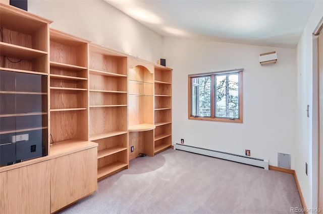 interior space with light carpet, vaulted ceiling, and a baseboard heating unit