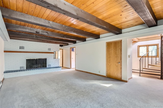 unfurnished living room featuring beamed ceiling, wood ceiling, a brick fireplace, a baseboard heating unit, and carpet