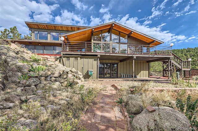 rear view of house featuring a wooden deck