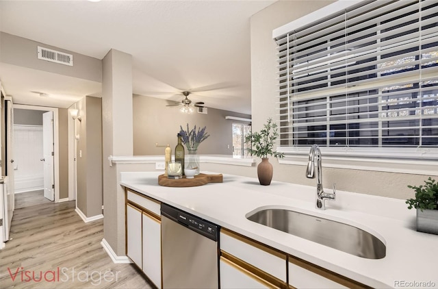 kitchen with sink, dishwasher, ceiling fan, light hardwood / wood-style floors, and white cabinets