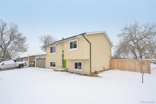 view of snow covered back of property