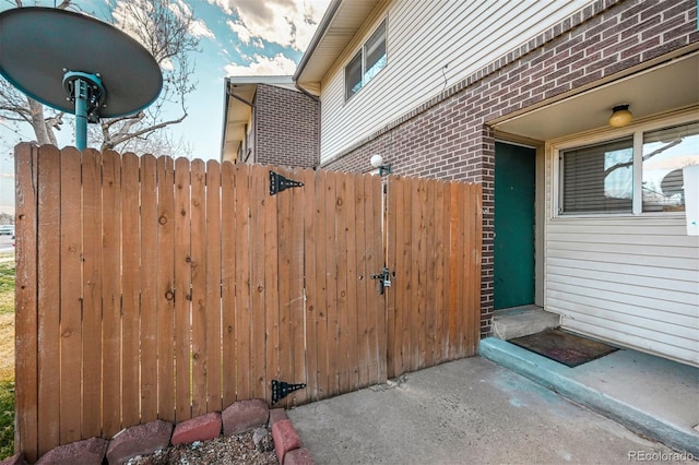 view of patio with a gate and fence