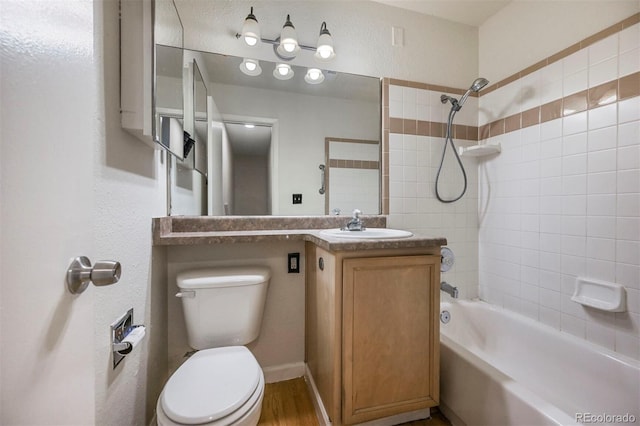 full bath with toilet, vanity, washtub / shower combination, and wood finished floors