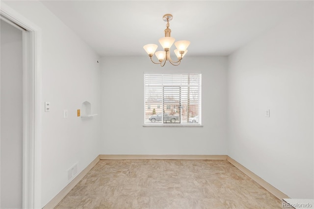 spare room featuring a notable chandelier