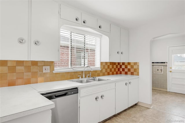 kitchen with dishwasher, sink, decorative backsplash, and white cabinets